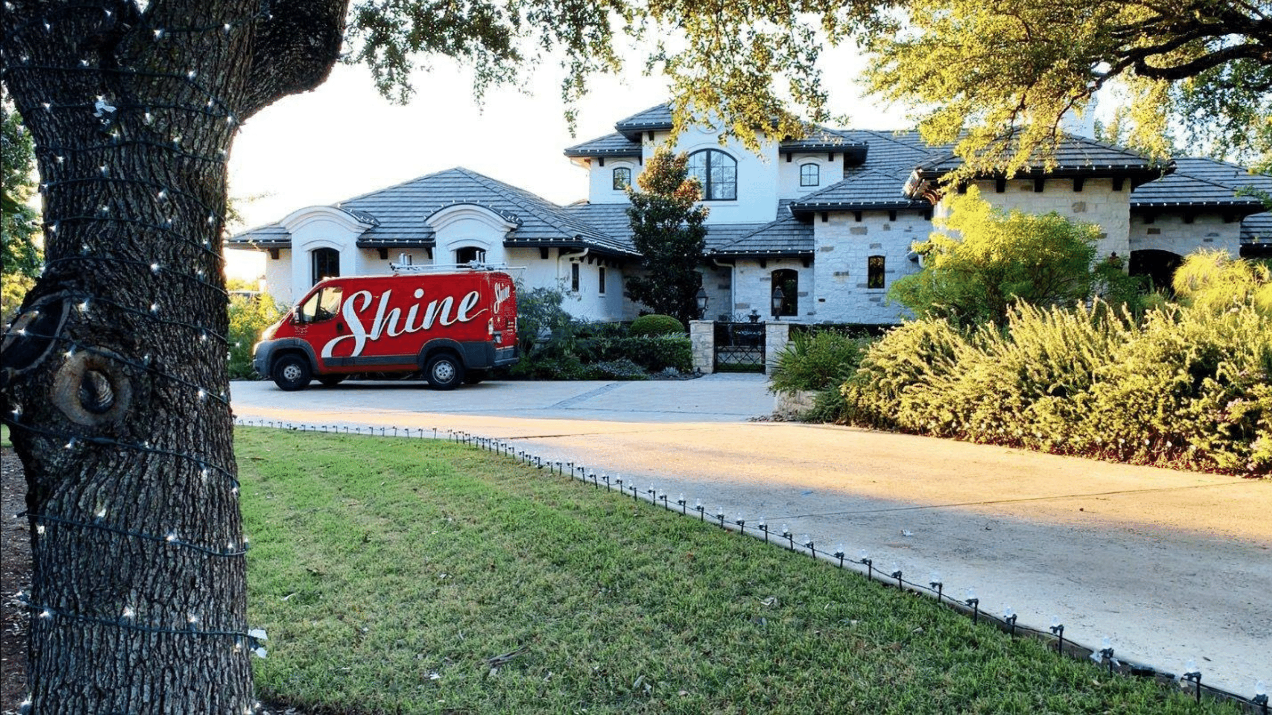 Shine Van Outside a House with tree wrap lighting