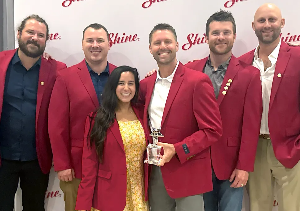 Shine Franchise owners celebrating success together at a franchise awards event.