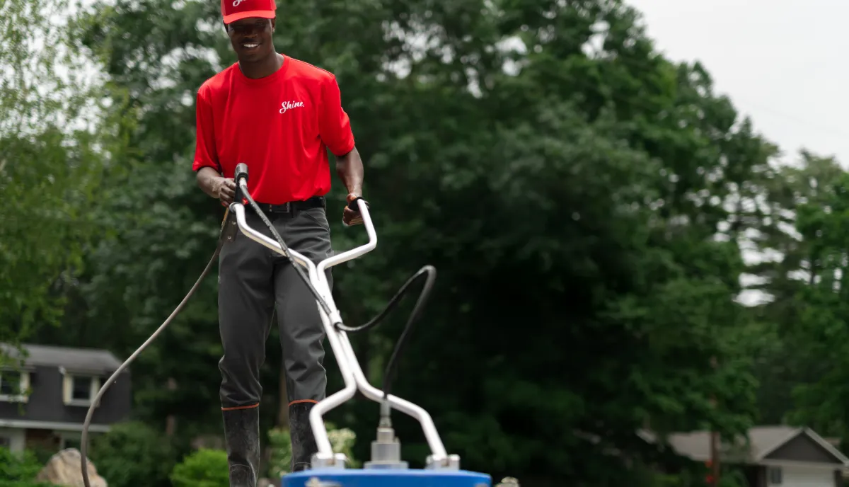 Shine technician operating professional cleaning equipment outdoors