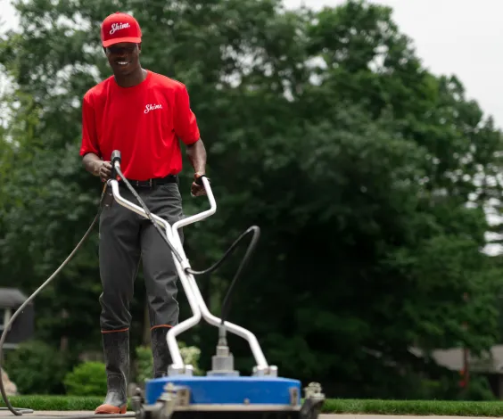 Shine technician operating professional cleaning equipment outdoors