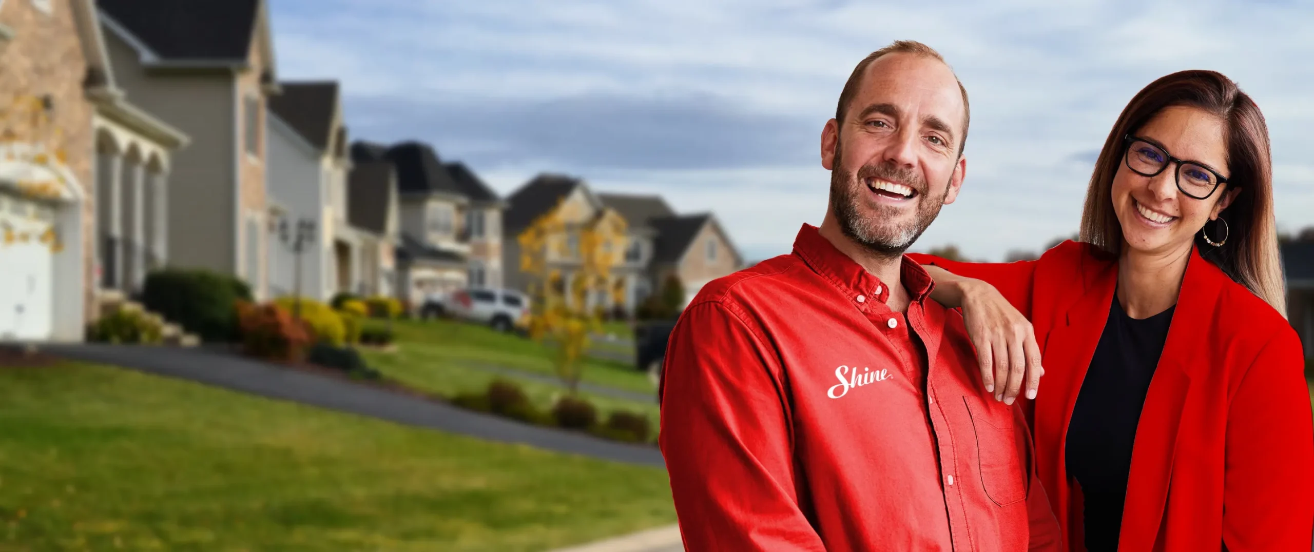 Shine Franchise owners standing in a residential neighborhood, representing a purpose-driven window cleaning and holiday lighting franchise.