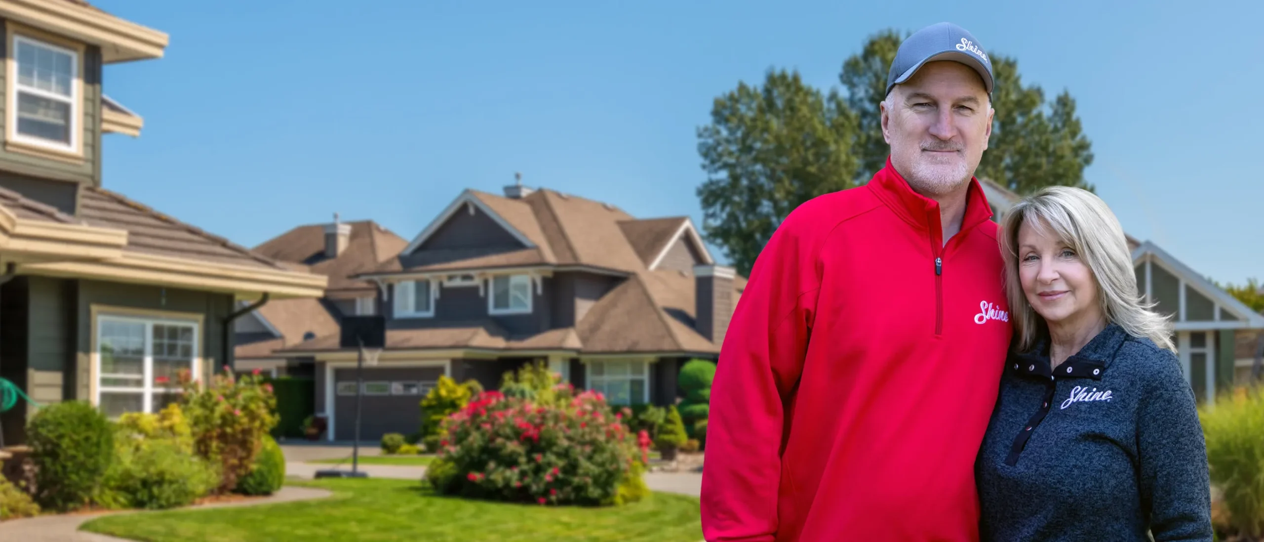 Shine Franchise owners standing in a residential neighborhood, representing a premium property care franchise.