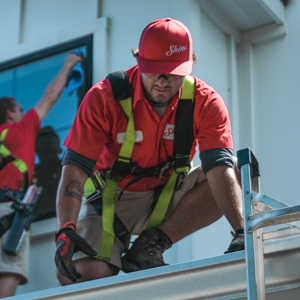 Shine employee performing gutter cleaning, home service franchise